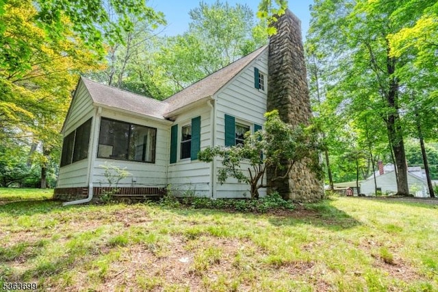 6 Penn Ave, Andover Twp, NJ 07860 - view of front of house featuring a chimney, a shingled roof, and a front lawn