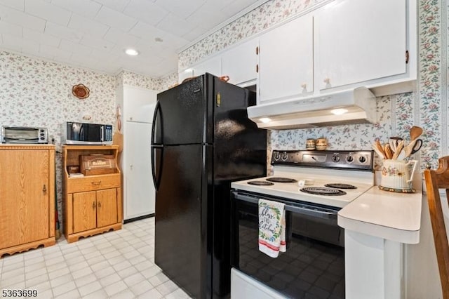 6 Penn Ave, Andover Twp, NJ 07860 - kitchen featuring wallpapered walls, electric range oven, under cabinet range hood, stainless steel microwave, and freestanding refrigerator
