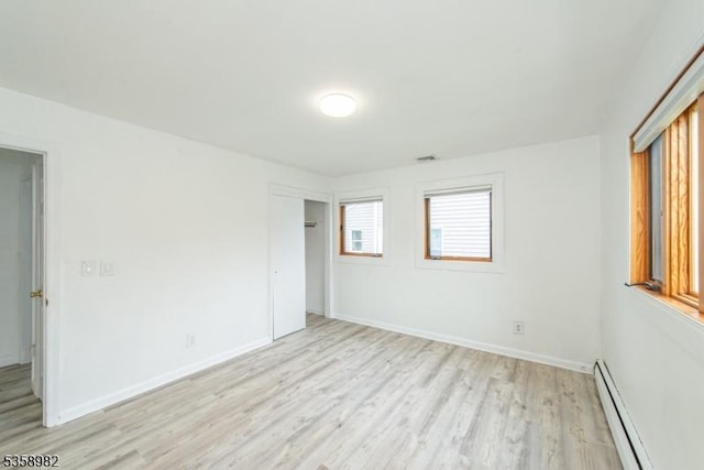 65 Beechwood Ave, Parsippany-Troy Hills Twp, NJ 07034 - unfurnished bedroom with baseboard heating, light wood-style flooring, and a closet