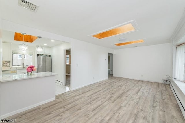 65 Beechwood Ave, Parsippany-Troy Hills Twp, NJ 07034 - unfurnished living room featuring attic access, a baseboard radiator, and light wood finished floors