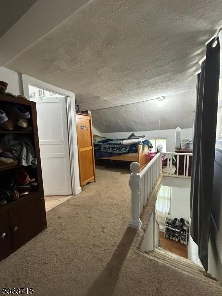100 Myrtle Ave, Washington Boro, NJ 07882 - bedroom with carpet floors, a textured ceiling, and lofted ceiling