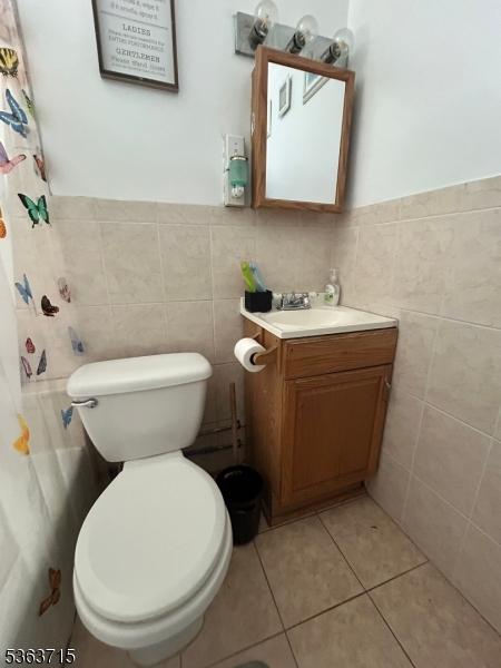 100 Myrtle Ave, Washington Boro, NJ 07882 - full bathroom featuring tile walls, vanity, toilet, wainscoting, and tile patterned flooring