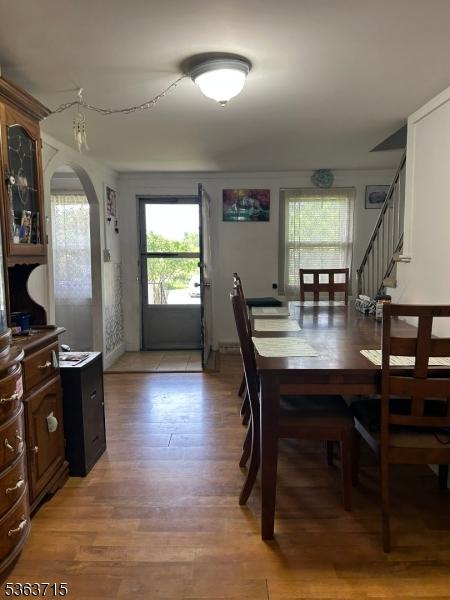 100 Myrtle Ave, Washington Boro, NJ 07882 - dining area featuring arched walkways, light wood-style flooring, and stairway