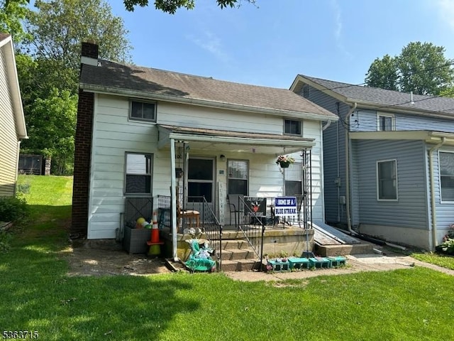 100 Myrtle Ave, Washington Boro, NJ 07882 - back of house featuring a chimney, covered porch, and a lawn