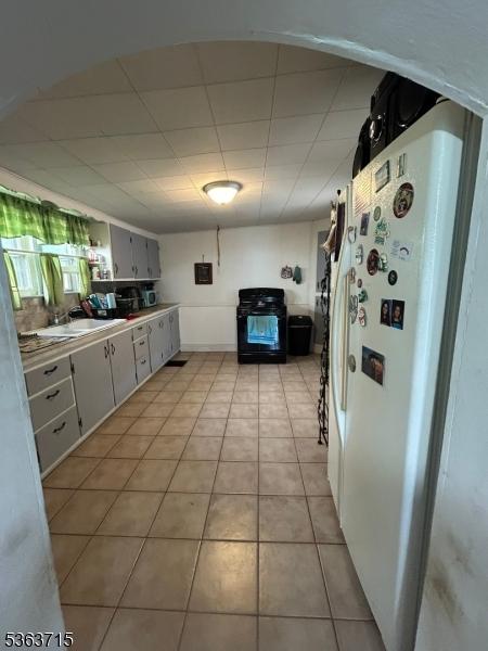 100 Myrtle Ave, Washington Boro, NJ 07882 - kitchen with freestanding refrigerator, light tile patterned floors, a sink, a drop ceiling, and gas stove