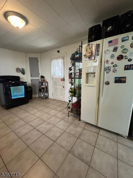 100 Myrtle Ave, Washington Boro, NJ 07882 - kitchen featuring white refrigerator with ice dispenser, gas stove, and light tile patterned flooring