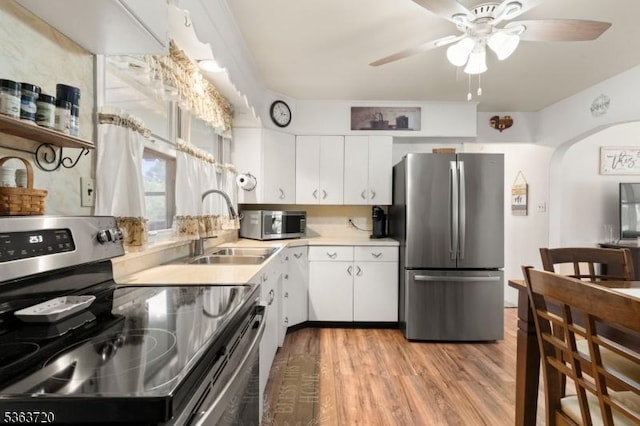 411 S 2nd St, Lopatcong Twp, NJ 08865 - kitchen featuring stainless steel appliances, a sink, arched walkways, ceiling fan, and light countertops