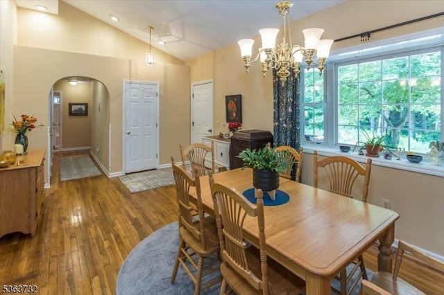 130 Lake Iliff Rd, Andover Twp, NJ 07860 - dining space with arched walkways, wood-type flooring, vaulted ceiling, and a chandelier