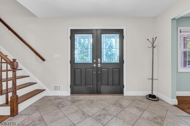 750 Saint Georges Rd, Bridgewater Twp, NJ 08807 - entrance foyer with plenty of natural light, stairway, tile patterned flooring, and french doors