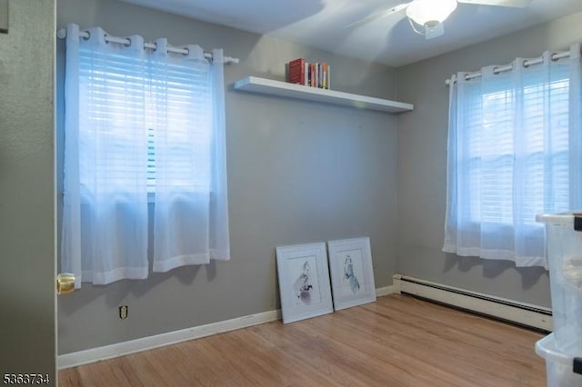 127 Walnut Ave, Franklin Twp, NJ 08873 - empty room featuring baseboard heating, wood finished floors, and ceiling fan