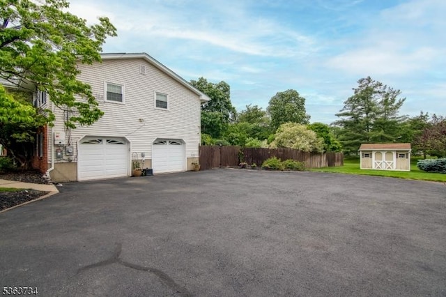 127 Walnut Ave, Franklin Twp, NJ 08873 - view of side of home featuring a storage shed, driveway, and an attached garage