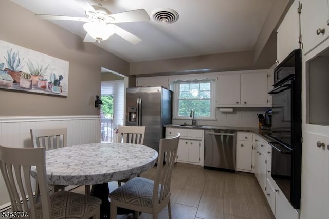 127 Walnut Ave, Franklin Twp, NJ 08873 - kitchen featuring stainless steel appliances, plenty of natural light, white cabinetry, and wainscoting