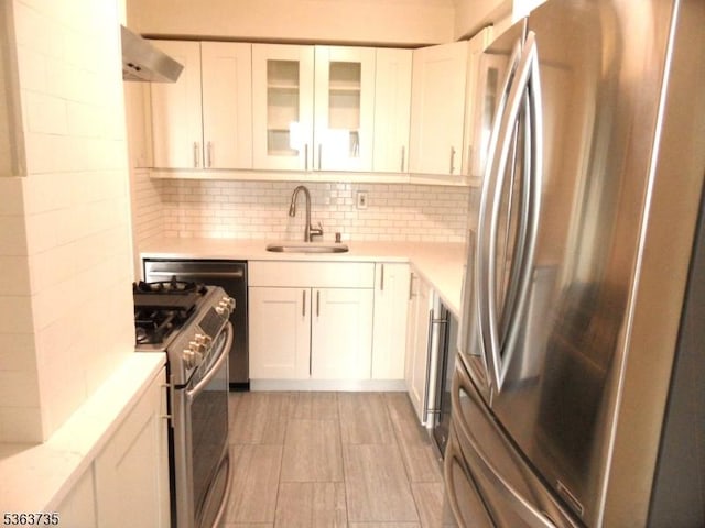 276 Prospect St, East Orange City, NJ 07017 - kitchen featuring appliances with stainless steel finishes, a sink, light countertops, and white cabinetry