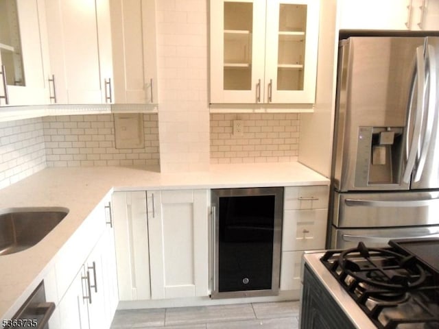 276 Prospect St, East Orange City, NJ 07017 - kitchen with stainless steel refrigerator with ice dispenser, wine cooler, white cabinetry, decorative backsplash, and glass insert cabinets