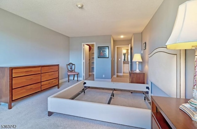 2 Claridge Dr Unit 7Ke, Verona Twp, NJ 07044 - bedroom featuring a spacious closet, carpet flooring, baseboards, and a textured ceiling