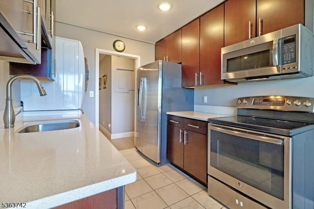 2 Claridge Dr Unit 7Ke, Verona Twp, NJ 07044 - kitchen featuring appliances with stainless steel finishes, a sink, light tile patterned floors, recessed lighting, and light stone counters