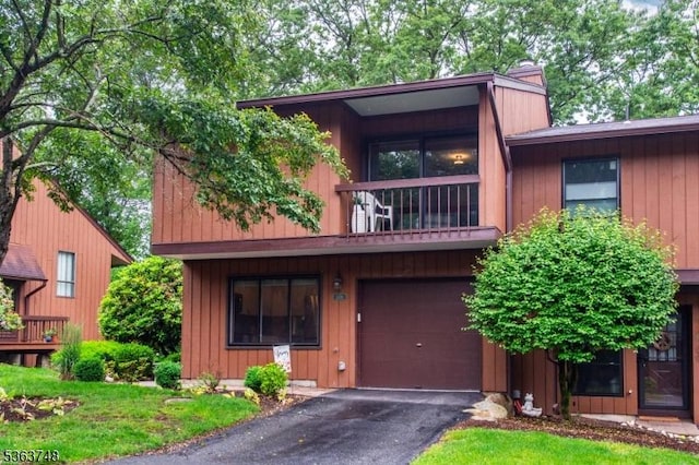 1176 Treetops, Wharton Boro, NJ 07885 - view of front facade with an attached garage, a balcony, a chimney, and driveway