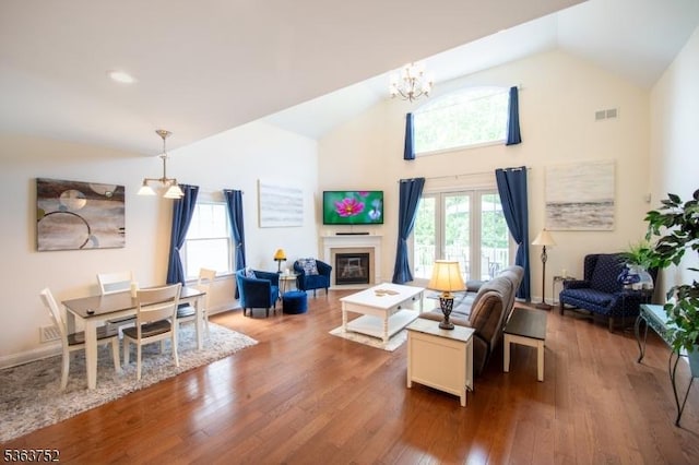42 Bluffs Ct, Hamburg Boro, NJ 07419 - living room with a chandelier, dark wood-style flooring, high vaulted ceiling, and a glass covered fireplace