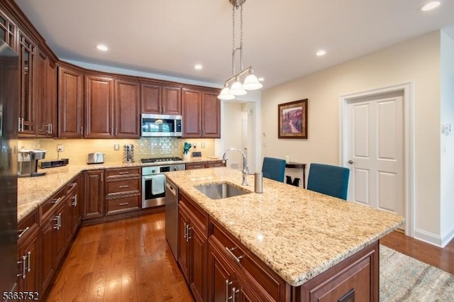 42 Bluffs Ct, Hamburg Boro, NJ 07419 - kitchen with appliances with stainless steel finishes, a sink, dark wood finished floors, tasteful backsplash, and light stone counters
