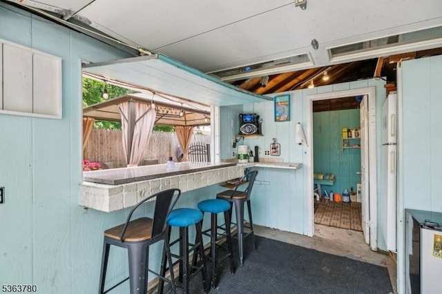 118 E Lincoln Ave, Roselle Park Boro, NJ 07204 - kitchen with plenty of natural light, concrete flooring, and wood walls