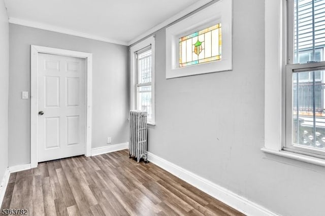 410-412 Kerrigan Blvd, Newark City, NJ 07106 - unfurnished bedroom featuring crown molding, baseboards, radiator, and wood finished floors