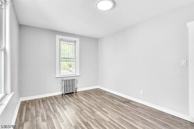 410-412 Kerrigan Blvd, Newark City, NJ 07106 - empty room with radiator, wood finished floors, and baseboards