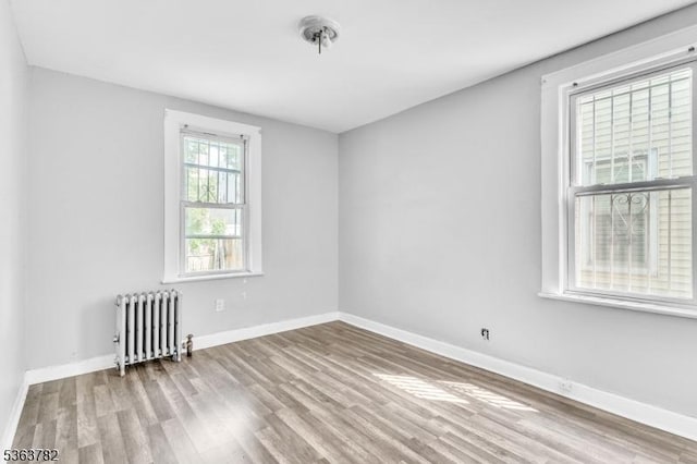 410-412 Kerrigan Blvd, Newark City, NJ 07106 - unfurnished room with radiator heating unit, wood finished floors, and baseboards