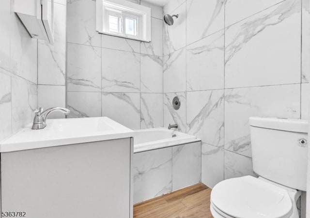 410-412 Kerrigan Blvd, Newark City, NJ 07106 - bathroom featuring toilet, tiled shower / bath combo, tile walls, wood finished floors, and vanity