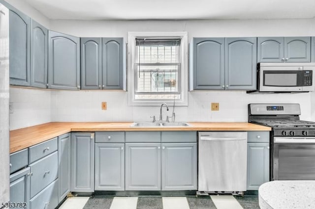 410-412 Kerrigan Blvd, Newark City, NJ 07106 - kitchen with stainless steel appliances, a sink, wooden counters, and decorative backsplash