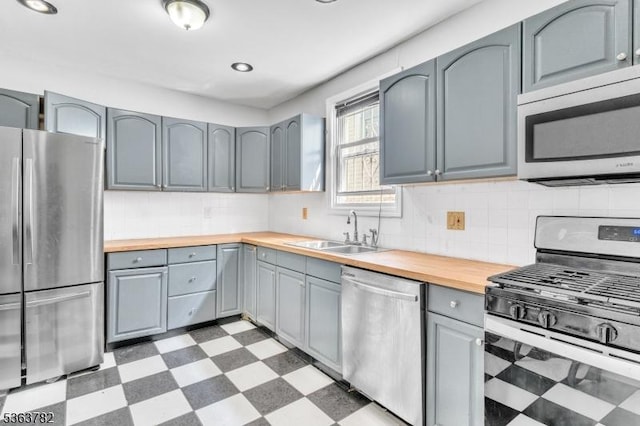 410-412 Kerrigan Blvd, Newark City, NJ 07106 - kitchen with appliances with stainless steel finishes, light floors, butcher block countertops, gray cabinetry, and recessed lighting