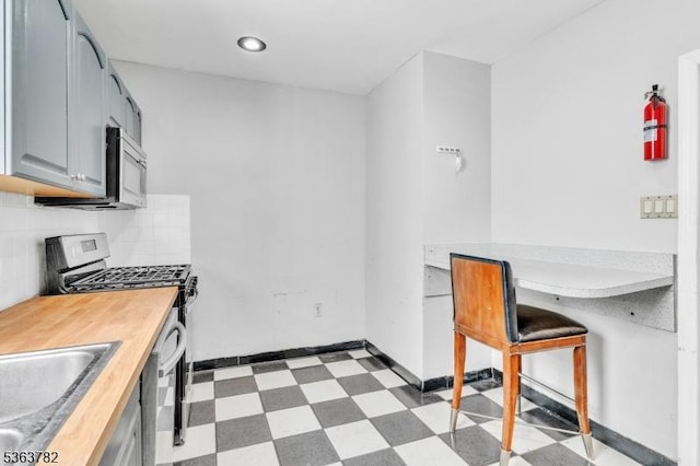 410-412 Kerrigan Blvd, Newark City, NJ 07106 - kitchen featuring stainless steel appliances, light floors, a sink, gray cabinetry, and decorative backsplash