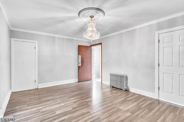410-412 Kerrigan Blvd, Newark City, NJ 07106 - empty room with radiator, a chandelier, wood finished floors, crown molding, and baseboards