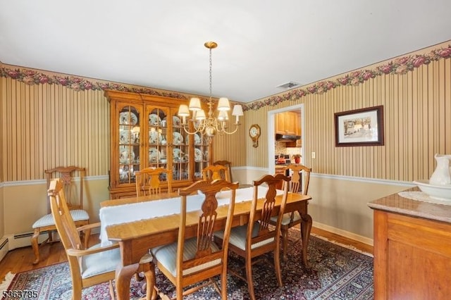 28 Douglas Dr, Washington Twp, NJ 07853 - dining space featuring wallpapered walls, a chandelier, and wood finished floors
