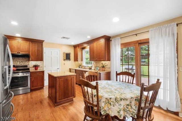 28 Douglas Dr, Washington Twp, NJ 07853 - kitchen featuring stainless steel appliances, under cabinet range hood, a kitchen island, tasteful backsplash, and healthy amount of natural light