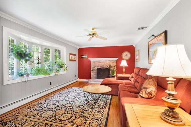 28 Douglas Dr, Washington Twp, NJ 07853 - living area with wood finished floors, crown molding, a baseboard radiator, ceiling fan, and a fireplace