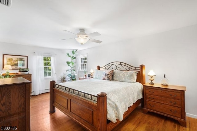 28 Douglas Dr, Washington Twp, NJ 07853 - bedroom featuring wood finished floors, ceiling fan, and a baseboard radiator