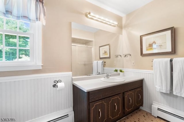 28 Douglas Dr, Washington Twp, NJ 07853 - bathroom featuring a baseboard radiator, a wainscoted wall, vanity, and a shower with shower door