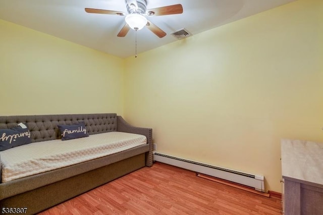 39 Mildred Ter, Clark Twp, NJ 07066 - bedroom with baseboard heating, wood finished floors, and ceiling fan