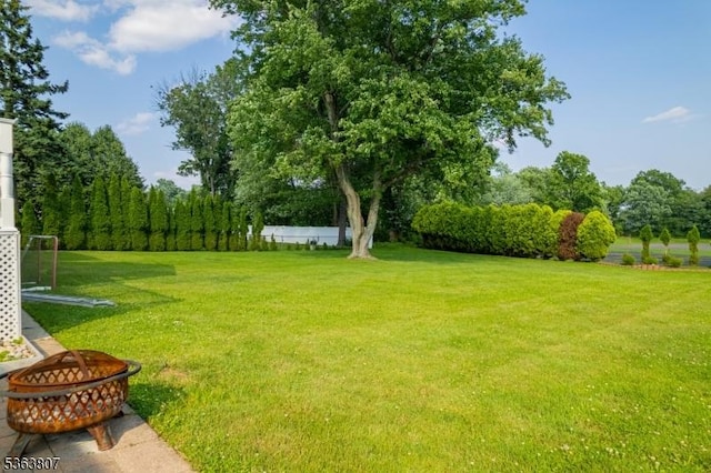 39 Mildred Ter, Clark Twp, NJ 07066 - view of grassy yard featuring an outdoor fire pit