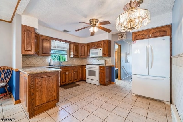 39 Mildred Ter, Clark Twp, NJ 07066 - kitchen featuring white appliances, brown cabinetry, decorative backsplash, and a textured ceiling
