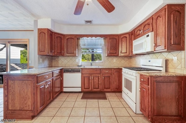 39 Mildred Ter, Clark Twp, NJ 07066 - kitchen featuring white appliances, a peninsula, brown cabinets, and a textured ceiling