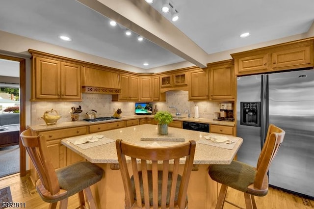 214 Glenside Pl, North Plainfield Boro, NJ 07060 - kitchen featuring stainless steel fridge with ice dispenser, gas stovetop, a center island, a breakfast bar, and backsplash