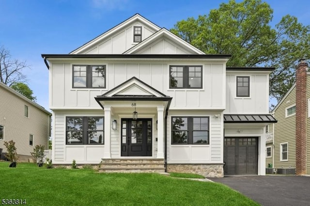 68 Irving Ave, Livingston Twp, NJ 07039 - view of front of property featuring board and batten siding, a garage, asphalt driveway, and a front lawn
