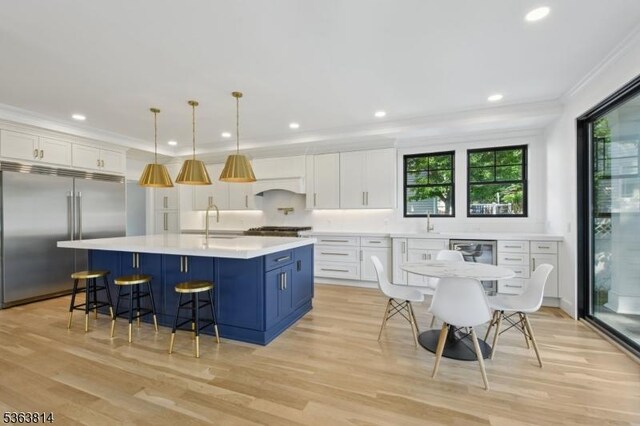68 Irving Ave, Livingston Twp, NJ 07039 - kitchen featuring stainless steel built in fridge, plenty of natural light, ornamental molding, custom range hood, and light countertops