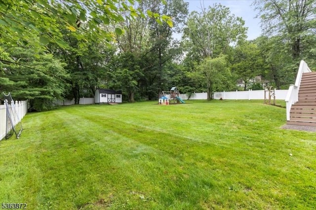 301 Diamond Hill Rd, Berkeley Heights Twp, NJ 07922 - fenced backyard featuring a playground, a shed, and view of scattered trees