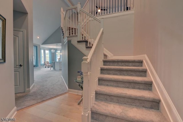 2409 Ramapo Ct, Riverdale Boro, NJ 07457 - stairway featuring high vaulted ceiling, carpet flooring, and a chandelier
