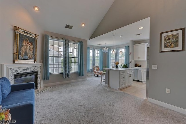 2409 Ramapo Ct, Riverdale Boro, NJ 07457 - kitchen featuring open floor plan, stainless steel dishwasher, light carpet, a chandelier, and white cabinetry