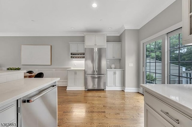 10 Central Ave Unit C, Caldwell Boro Twp, NJ 07006 - kitchen with appliances with stainless steel finishes, light countertops, white cabinetry, ornamental molding, and light wood-style floors