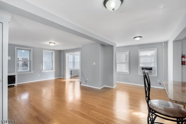 136 Willow St, Bloomfield Twp, NJ 07003 - unfurnished living room with baseboards, light wood finished floors, radiator, and cooling unit