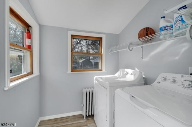 136 Willow St, Bloomfield Twp, NJ 07003 - washroom with radiator heating unit, washer and clothes dryer, plenty of natural light, and wood finished floors